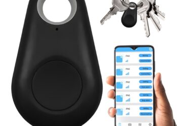Srebrny pęk kluczy z niebieskim lokalizatorem bluetooth bezpiecznie spoczywa na szklanym stoliku