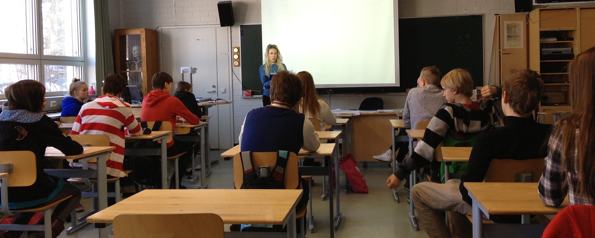 czytanie bajek w fińskiej klasie nauczyciel czytający książkę grupie dzieci siedzących na dywanie