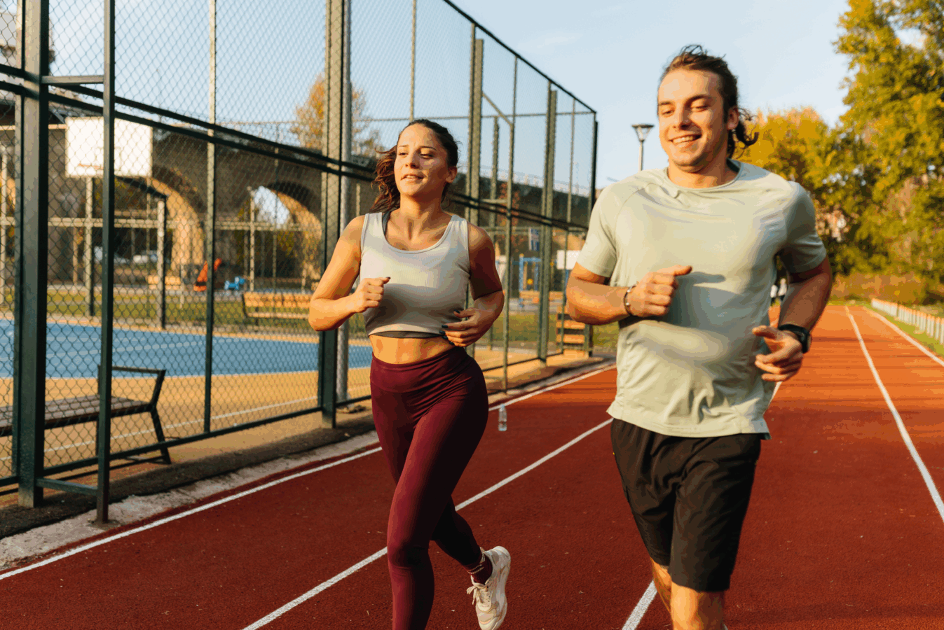 nawodnienie po biegu roześmiany sportowiec pijący wodę z butelki po biegu